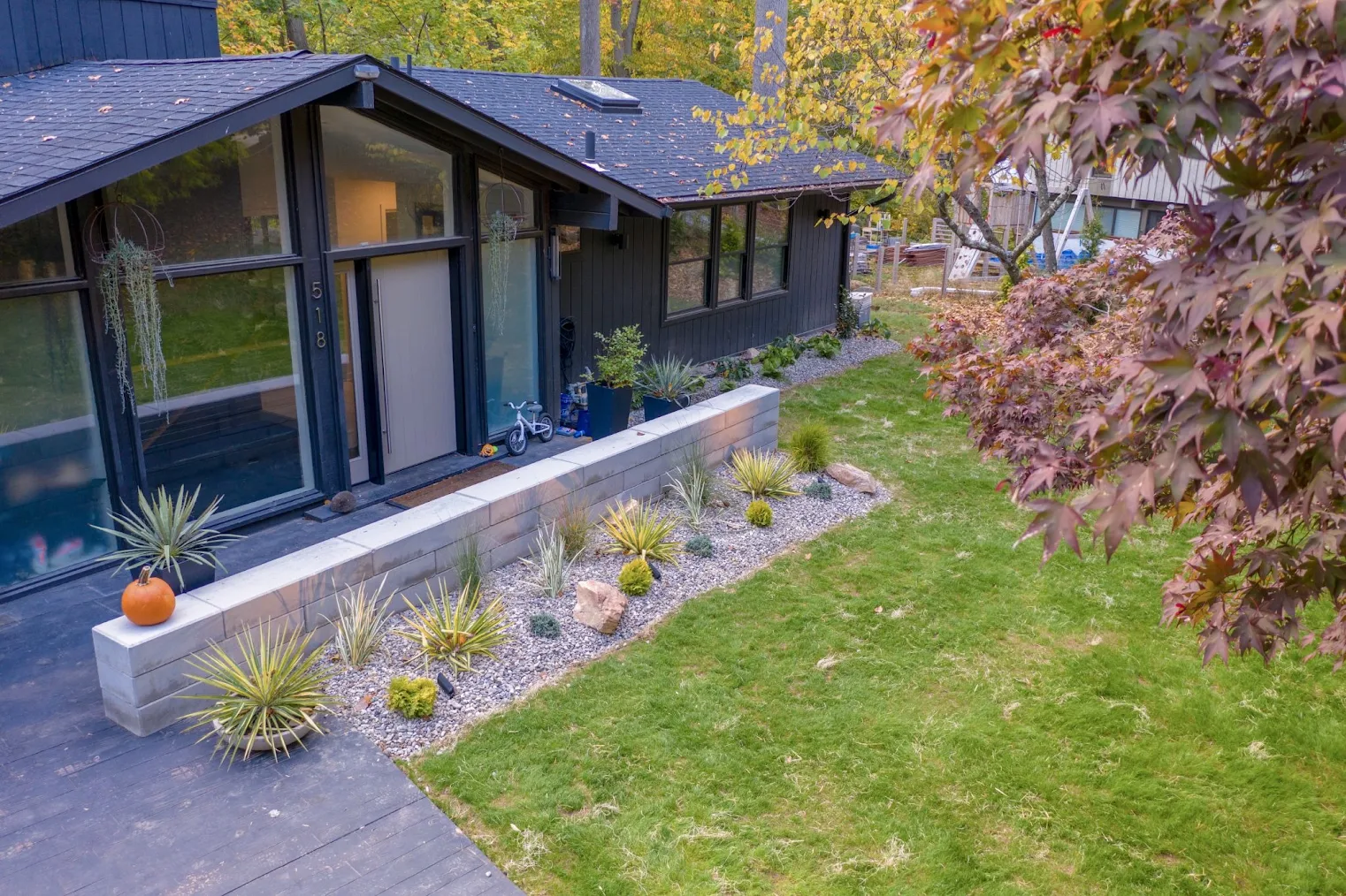 an aerial view of a home and yard on a fall day.